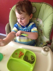 Meal times were awful. We could hardly leave him alone in the high chair. His feet would be "scissoring" or "cricketing" as we called it. And here he is scratching with his fork. 